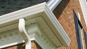 A close-up image of a seamless gutter and downspout system.