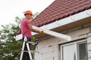 Installation Of Gutter System by a Worker